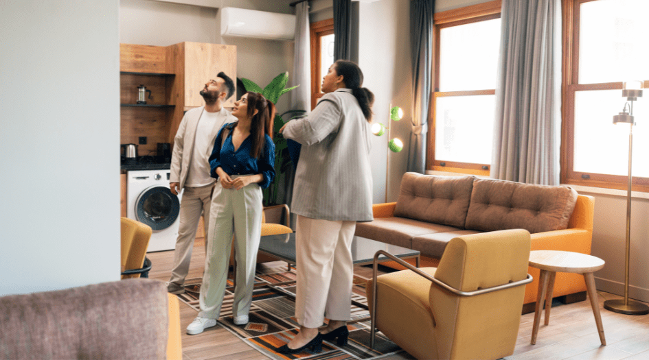 Three people inspect the interior of a home, showing the importance of preparing for a home inspection as a seller.