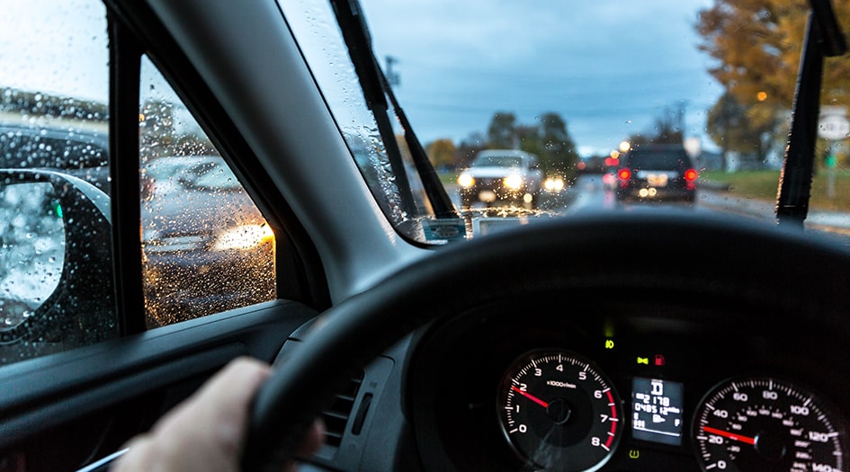 It is important to know what different vehicle dashboard warning lights mean, as shown by a close-up of a car dashboard with four different warning lights on