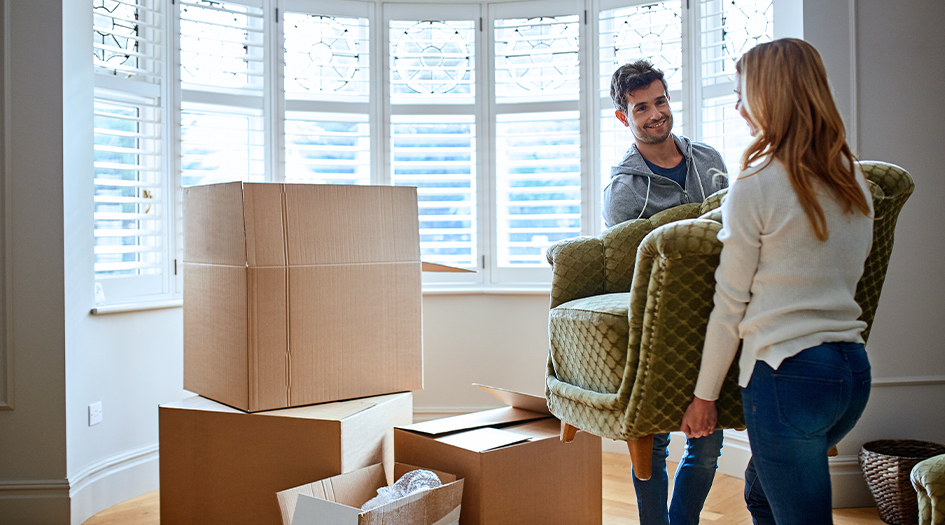 Here's a homeowner's guide to shopping for home insurance, as shown by a man and woman moving an armchair