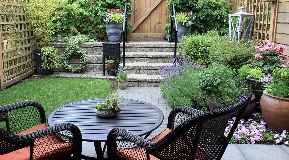 A backyard with a patio, seating area, and garden illustrates how you can design a safe and stylish patio