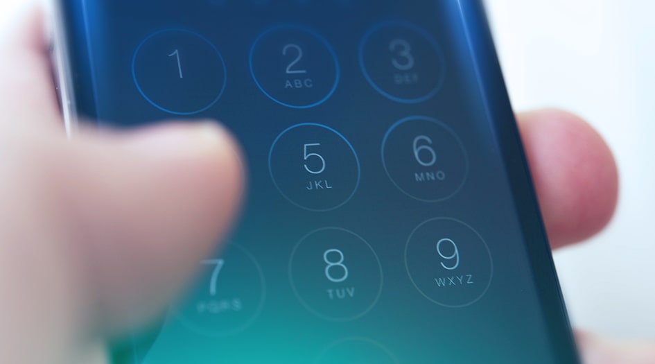 A close up shows fingers entering a password on a mobile phone, which is a simple way to protect yourself against identify theft