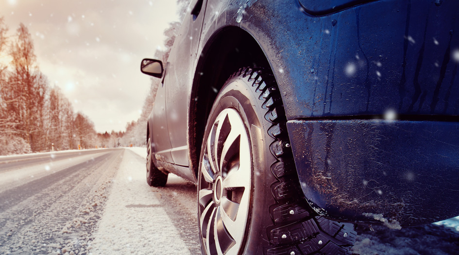 A close up of a car’s back bumper on a snowy road shows how crumple zones work.