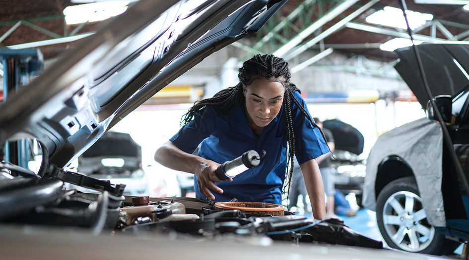 A mechanic inspects the engine of a car, showing what you need to know about your insurance company's certified repair facilities
