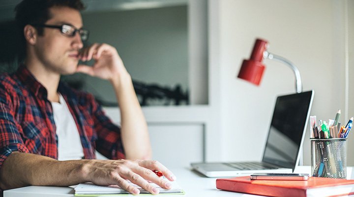 Make sure to research some surprising facts every renter should know, as shown by a man browsing on his laptop