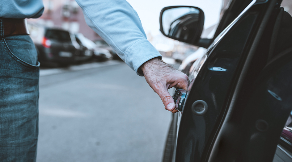 Here's what depreciation is in car insurance, as shown by a close up of someone opening a car door