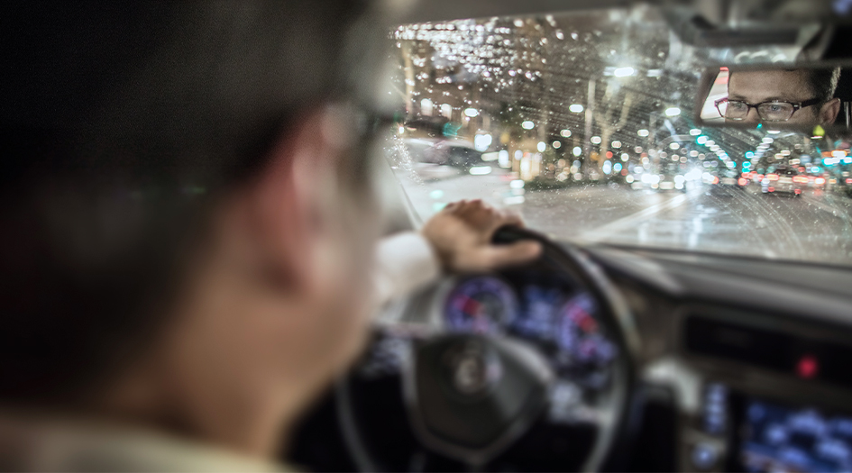 A close up of a man driving in the rain shows you how you can stop hydroplaning