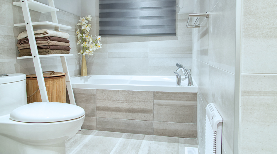 Keep your septic system working properly by maintaining your faucets, as shown by a white bathroom with a tub and toilet