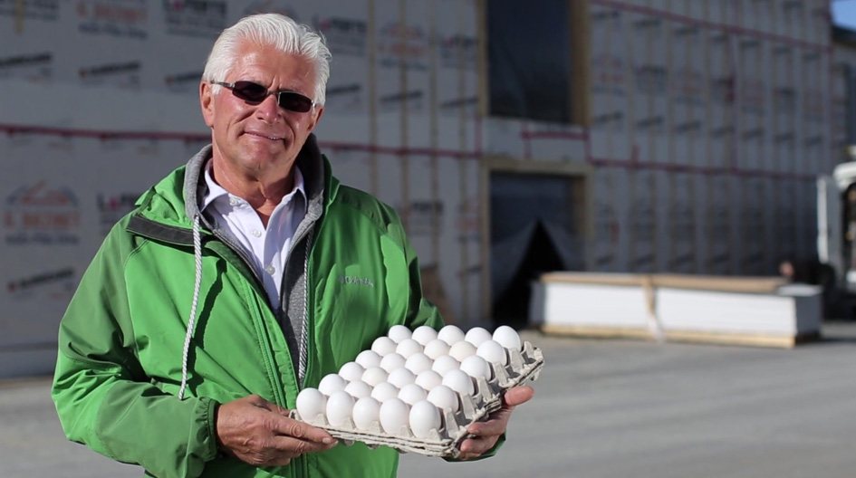 An Economical customer holds a rack of 30 eggs