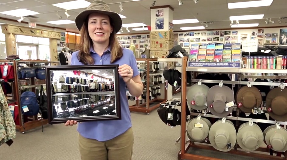 An Economical customer hold a picture of her flood damanged store