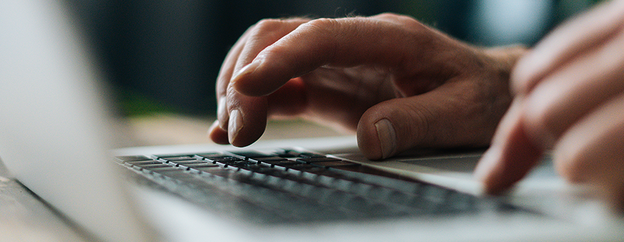 hands typing on a keyboard