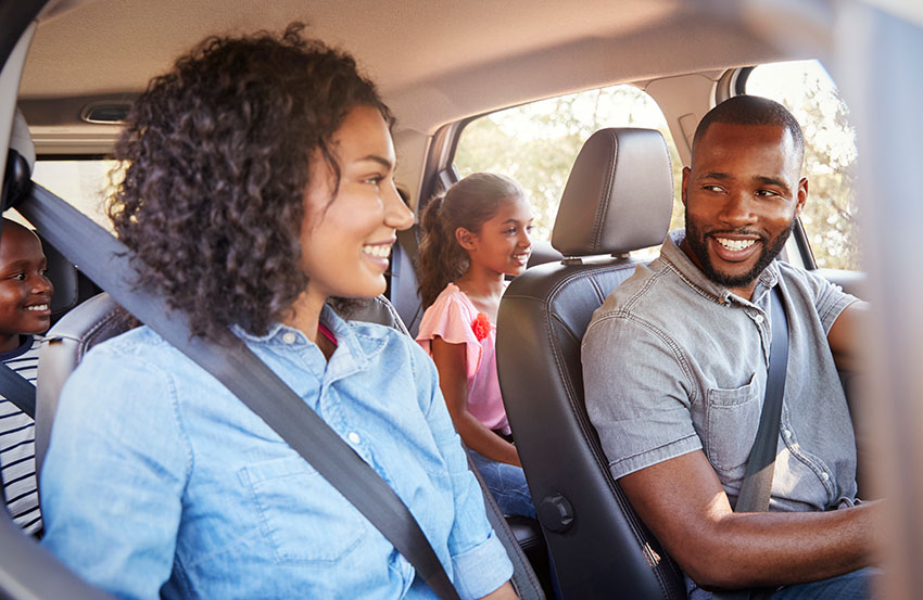 A family enjoying a ride in their car