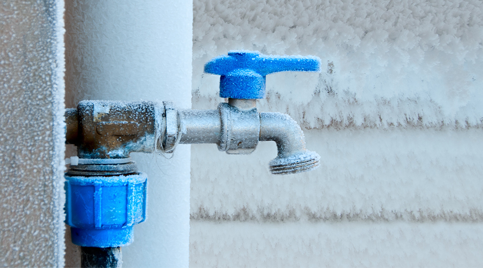 A hose bib is covered in frost, showing how to prevent your hose bib from freezing